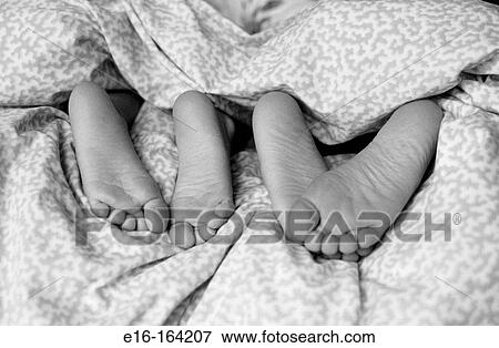 Kids feet in bed View Large Photo Image Stock Photo - Kids feet in bed. Fotosearch