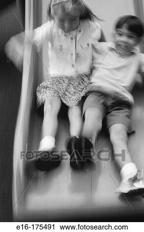 Stock Image - Kids on park slide. Fotosearch