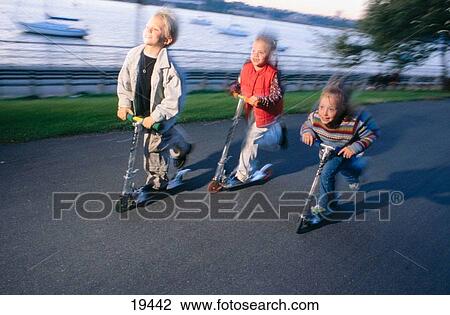 Kids on scooters View Large Photo Image Stock Image - Kids on scooters. Fotosearch