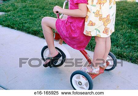 Kids on tricycle View Large Photo Image Stock Photography - Kids on tricycle. Fotosearch