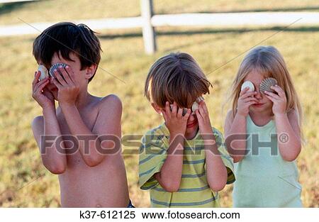 Kids on vacation with shells over there eyes View Large Photo Image Stock Photography - Kids on vacation with shells over there eyes. Fotosearch