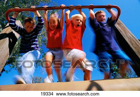 Kids playing on a roller at the playground View Large Photo Image Picture - Kids playing on a roller at the playground. Fotosearch