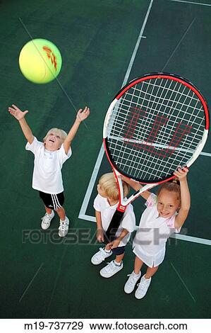 Stock Photo - Kids playing with an oversized tennis racket and ball. Fotosearch