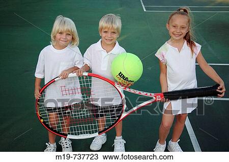 Stock Image - Kids posing with an oversized tennis racket and ball. Fotosearch