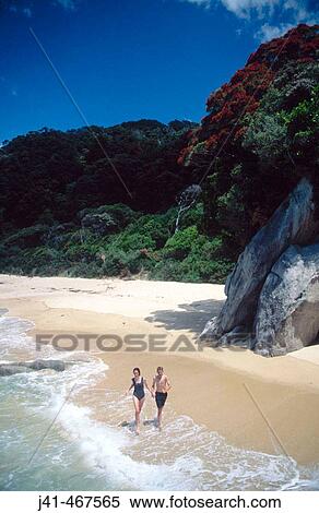 Kids running along beach. Abel Tasman National Park. New Zealand. View Large Photo Image Stock Photography - Kids running along beach. Abel Tasman National Park. New Zealand.. Fotosearch