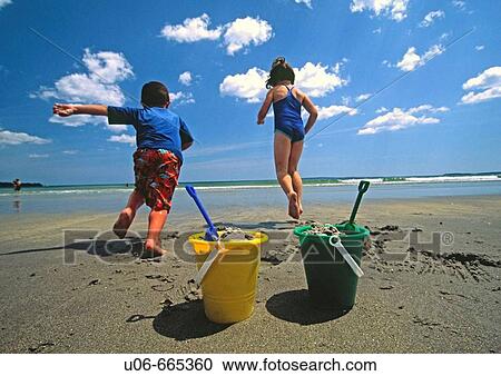 Kids running into the water at the beach View Large Photo Image Stock Image - Kids running into the water at the beach. Fotosearch