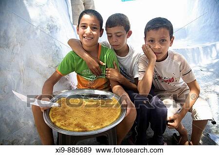 Kids selling cakes on the street, Chefchaouen, Morocco View Large Photo Image Stock Photo - Kids selling cakes on the street, Chefchaouen, Morocco. Fotosearch