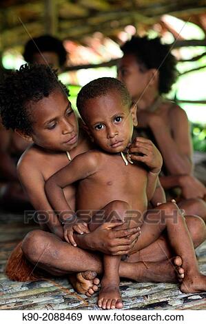 Kids sitting on the floor, Papua, Indonesia, Southeast Asia. View Large Photo Image Stock Photo - Kids sitting on the floor, Papua, Indonesia, Southeast Asia.. Fotosearch