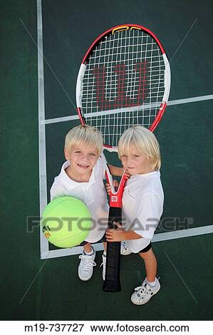 Stock Photo - Kids with an oversized tennis racket and ball. Fotosearch