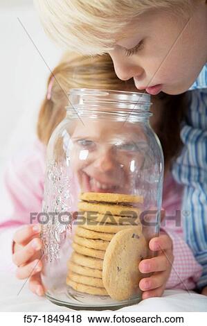 Kids with their hand in the cookie jar View Large Photo Image Stock Photo - Kids with their hand in the cookie jar. Fotosearch