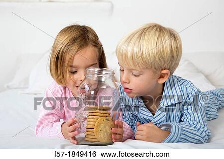 Kids with their hand in the cookie jar View Large Photo Image Stock Photograph - Kids with their hand in the cookie jar. Fotosearch