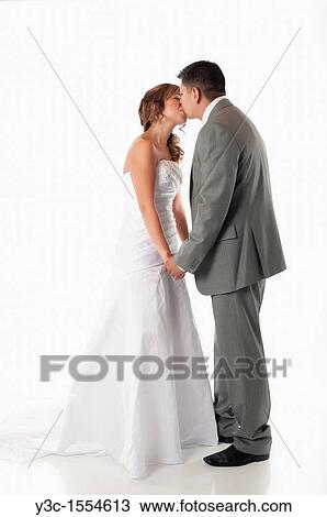 Kiss between bride and groom View Large Photo Image Stock Image - Kiss between bride and groom. Fotosearch