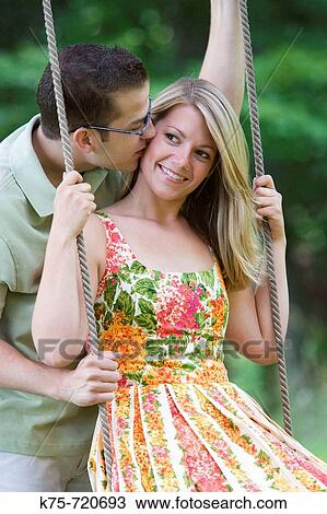Kiss on a swing View Large Photo Image Stock Image - Kiss on a swing. Fotosearch