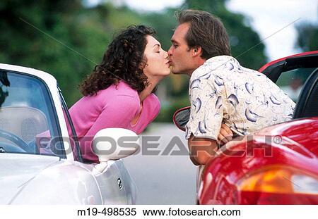 kissing couple in two convertible cars View Large Photo Image Stock Photography - kissing couple in two convertible cars. Fotosearch