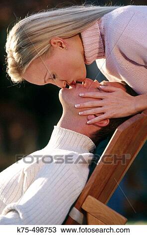 Stock Image - Kissing him. Fotosearch