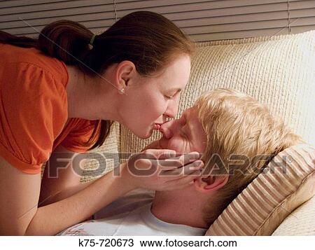 Stock Image - Kissing on the couch. Fotosearch