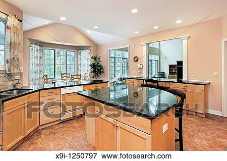 Kitchen in luxury home with marble top island View Large Photo Image Stock Photo - Kitchen in luxury home with marble top island. Fotosearch