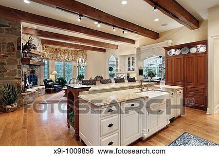 Kitchen in luxury home with stone fireplace View Large Photo Image Stock Photograph - Kitchen in luxury home with stone fireplace. Fotosearch