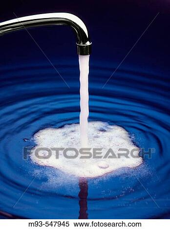 Kitchen-style faucet with water running into large pool of blue water View Large Photo Image Stock Photography - Kitchen-style faucet with water running into large pool of blue water. Fotosearch