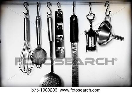 Kitchen utensils hanging on a wall View Large Photo Image Stock Image - Kitchen utensils hanging on a wall. Fotosearch