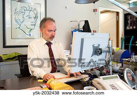 Klosterstrasse, East-Berlin, Berlin, Germany. Senior adult man, working as a consular employee at the Dutch Embassy in Berlin, assisting the travelers and others with their needs. View Large Photo Image Stock Photo - Klosterstrasse, East-Berlin, Berlin, Germany. Senior adult man, working as a consular employee at the Dutch Embassy in Berlin, assisting the travelers and others with their needs.. Fotosearch