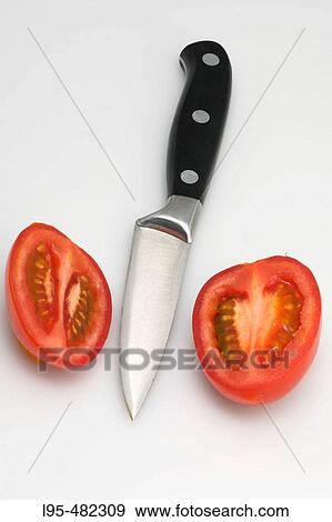 Knife and tomatoe halves View Large Photo Image Stock Photo - Knife and tomatoe halves. Fotosearch