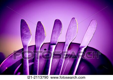 Knives on a stack of dishes. View Large Photo Image Stock Image - Knives on a stack of dishes.. Fotosearch