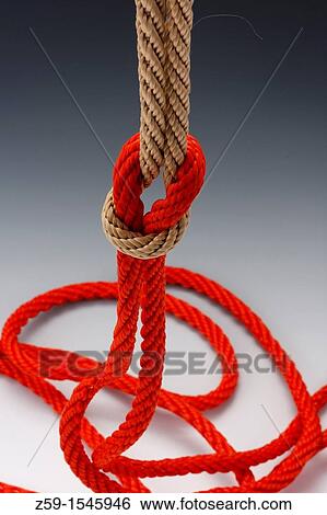 Stock Photograph - knots of orange and natural colored rope. Fotosearch