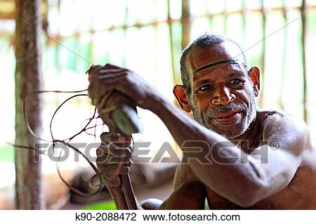 Kombai man making a stone axe, Papua, Indonesia, Southeast Asia. View Large Photo Image Stock Image - Kombai man making a stone axe, Papua, Indonesia, Southeast Asia.. Fotosearch