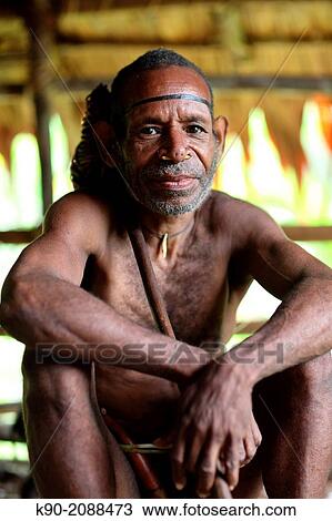 Kombai man sitting with stone axe on his shoulder, Papua, Indonesia, Southeast Asia. View Large Photo Image Stock Image - Kombai man sitting with stone axe on his shoulder, Papua, Indonesia, Southeast Asia.. Fotosearch