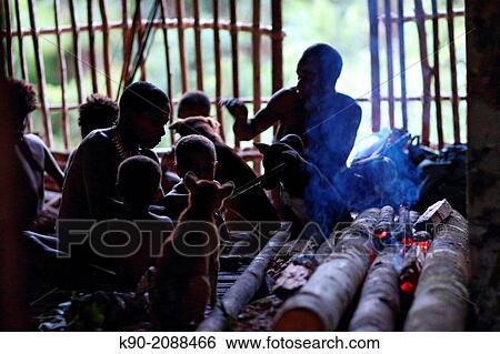 Kombai people sitting in their wooden house on the floor, Papua, Indonesia, Southeast Asia. View Large Photo Image Stock Photograph - Kombai people sitting in their wooden house on the floor, Papua, Indonesia, Southeast Asia.. Fotosearch