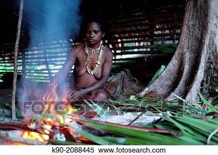 Kombai woman at the fire place in a traditional hut and grilling bananas, Papua, Indonesia, Southeast Asia. View Large Photo Image Stock Photography - Kombai woman at the fire place in a traditional hut and grilling bananas, Papua, Indonesia, Southeast Asia.. Fotosearch