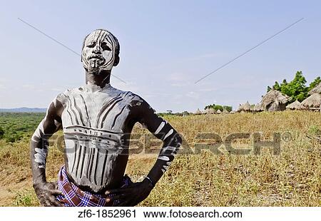 Stock Image - Korcho Ethiopia Africa village Lower Omo Valley Karo tribe young warrior with white painted face 25. Fotosearch