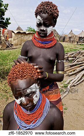 Korcho Ethiopia Africa village Lower Omo Valley Karo tribe with painted faces fixing red hair curls 25 View Large Photo Image Stock Image - Korcho Ethiopia Africa village Lower Omo Valley Karo tribe with painted faces fixing red hair curls 25. Fotosearch