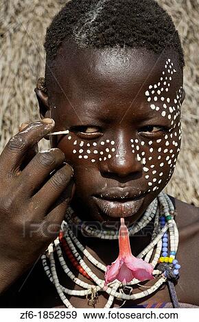 Korcho Ethiopia Africa village Lower Omo Valley Karo tribe putting on makeup paint on face 25 View Large Photo Image Stock Photo - Korcho Ethiopia Africa village Lower Omo Valley Karo tribe putting on makeup paint on face 25. Fotosearch