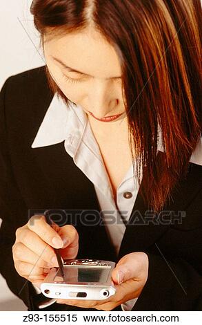 Stock Photography - Korean Business Woman using pocket p. c. Fotosearch