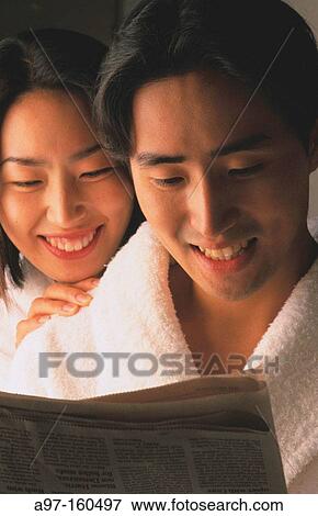 Korean couple reading newspaper View Large Photo Image Stock Photo - Korean couple reading newspaper. Fotosearch