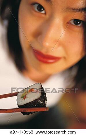 Korean woman eating sushi View Large Photo Image Stock Image - Korean woman eating sushi. Fotosearch