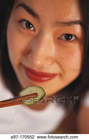Korean Woman eating with chopsticks View Large Photo Image Stock Image - Korean Woman eating with chopsticks. Fotosearch