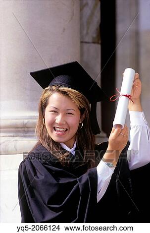 Picture - Korean woman holding diploma celebrates graduation from university, Canada, Ontario. Fotosearch