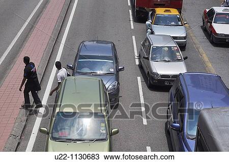 Kuala Lumpur (Malaysia): pedestrians crossing Jalan Petaling, the main street by Chinatown View Large Photo Image Stock Image - Kuala Lumpur (Malaysia): pedestrians crossing Jalan Petaling, the main street by Chinatown. Fotosearch