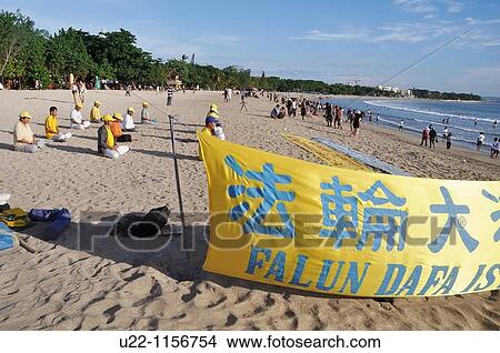 Kuta Beach (Bali, Indonesia): Falun Gong believers, meditating on the shore View Large Photo Image Picture - Kuta Beach (Bali, Indonesia): Falun Gong believers, meditating on the shore. Fotosearch