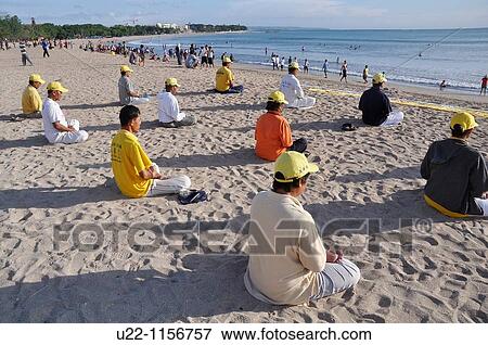 Kuta Beach (Bali, Indonesia): Falun Gong believers, meditating on the shore View Large Photo Image Stock Photo - Kuta Beach (Bali, Indonesia): Falun Gong believers, meditating on the shore. Fotosearch