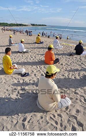 Kuta Beach (Bali, Indonesia): Falun Gong believers, meditating on the shore View Large Photo Image Stock Photo - Kuta Beach (Bali, Indonesia): Falun Gong believers, meditating on the shore. Fotosearch