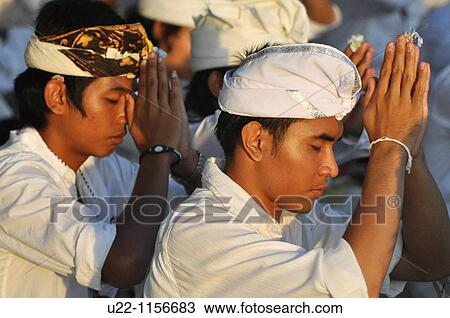Kuta Beach (Bali, Indonesia): men at a collective pray during a Hindu ritual on the beach View Large Photo Image Stock Image - Kuta Beach (Bali, Indonesia): men at a collective pray during a Hindu ritual on the beach. Fotosearch