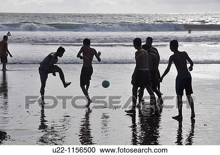 Kuta Beach (Bali, Indonesia): some youngsters playing soccer on the shore at sunset View Large Photo Image Stock Image - Kuta Beach (Bali, Indonesia): some youngsters playing soccer on the shore at sunset. Fotosearch