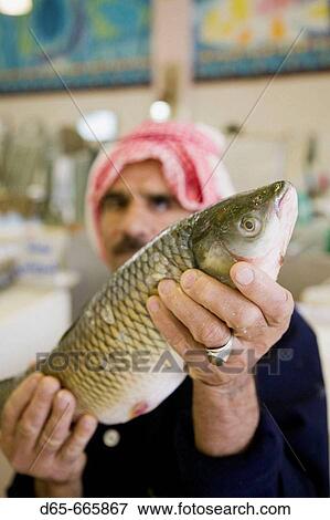 Stock Photo - KUWAIT-Kuwait City: Kuwait City Fish Market - Fish Monger. Fotosearch