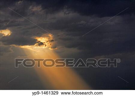 Stock Photo - Kyrgyzstan - Toktogul - stormclouds and sunset above mountains. Fotosearch