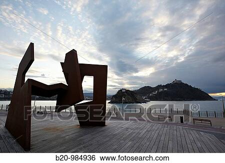 Stock Photograph - La Concha bay in the evening,? Construccion Vacia? sculpture by de Jorge Oteiza at fore, San Sebastian, Donostia, Gipuzkoa, Euskadi, Spain. Fotosearch