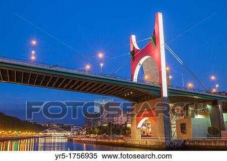 Stock Photography - La Salve bridge Zubizuri bridge in distance in Bilbao, Basque Country, Spain. Fotosearch